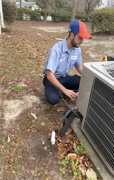 A+ Air Conditioning & Refrigeration technician servicing AC unit
