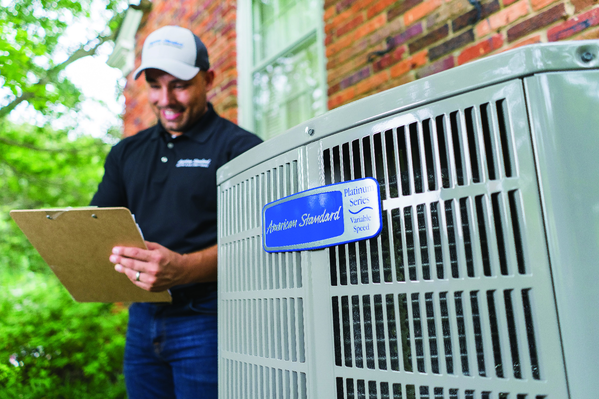 A technician assessing an American Standard cooling system | AC Repair in Gainesville, FL