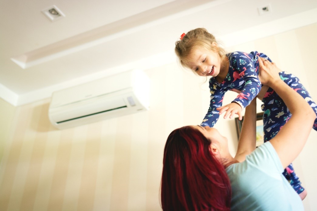 A mother playing with her child at home. | Installing Heat Pumps