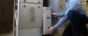 A person holding a major appliance | duct cleaning service | A Plus Air Conditioning and Refrigeration