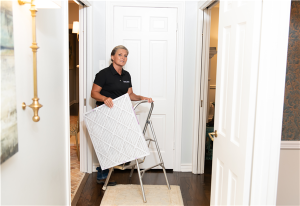 woman installing clean ac filters